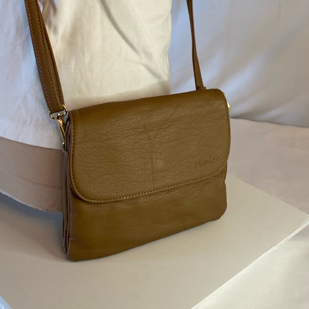 Inicat brand Minicat light brown/ tan Crossbody bag with snap closure